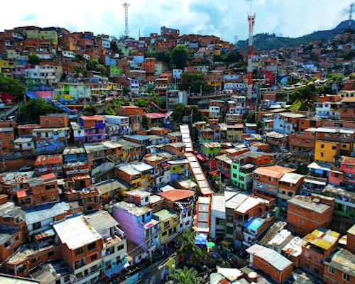 Colorful street art and outdoor escalators during Tour Comuna 13 in Medellín, Colombia.